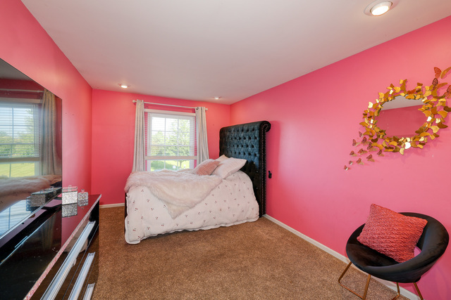 4579 Half Moon Drive, Unit D Yorkville, IL 60560 - Photo 20 of 44 a bed room with a bed and a chair