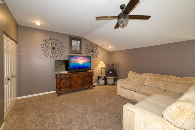 4579 Half Moon Drive, Unit D Yorkville, IL 60560 - Photo 21 of 44 a living room with furniture and a flat screen tv