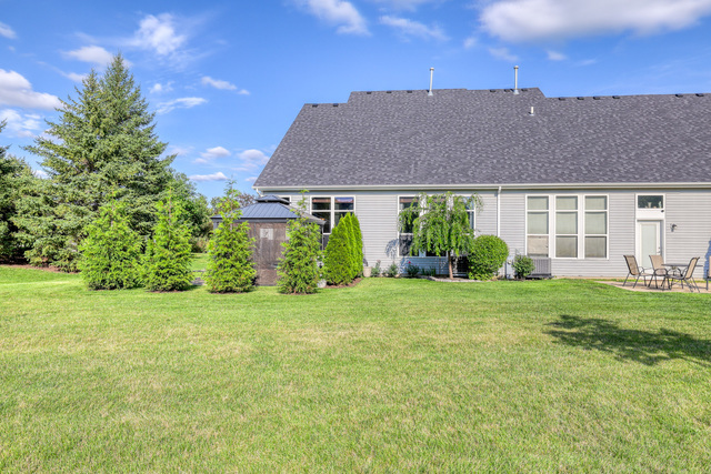 4579 Half Moon Drive, Unit D Yorkville, IL 60560 - Photo 24 of 44 a view of a big house with a big yard and large trees