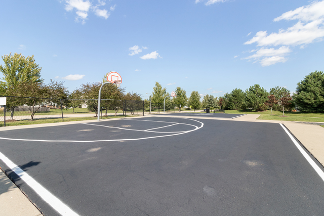 4579 Half Moon Drive, Unit D Yorkville, IL 60560 - Photo 32 of 44 a view of a tennis court