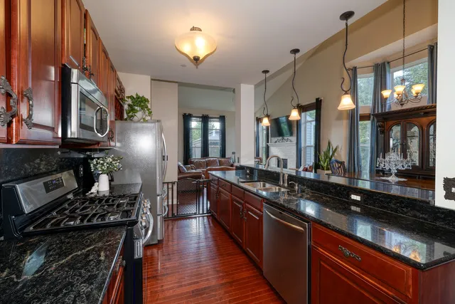 a kitchen with lots of counter top space and stainless steel appliances