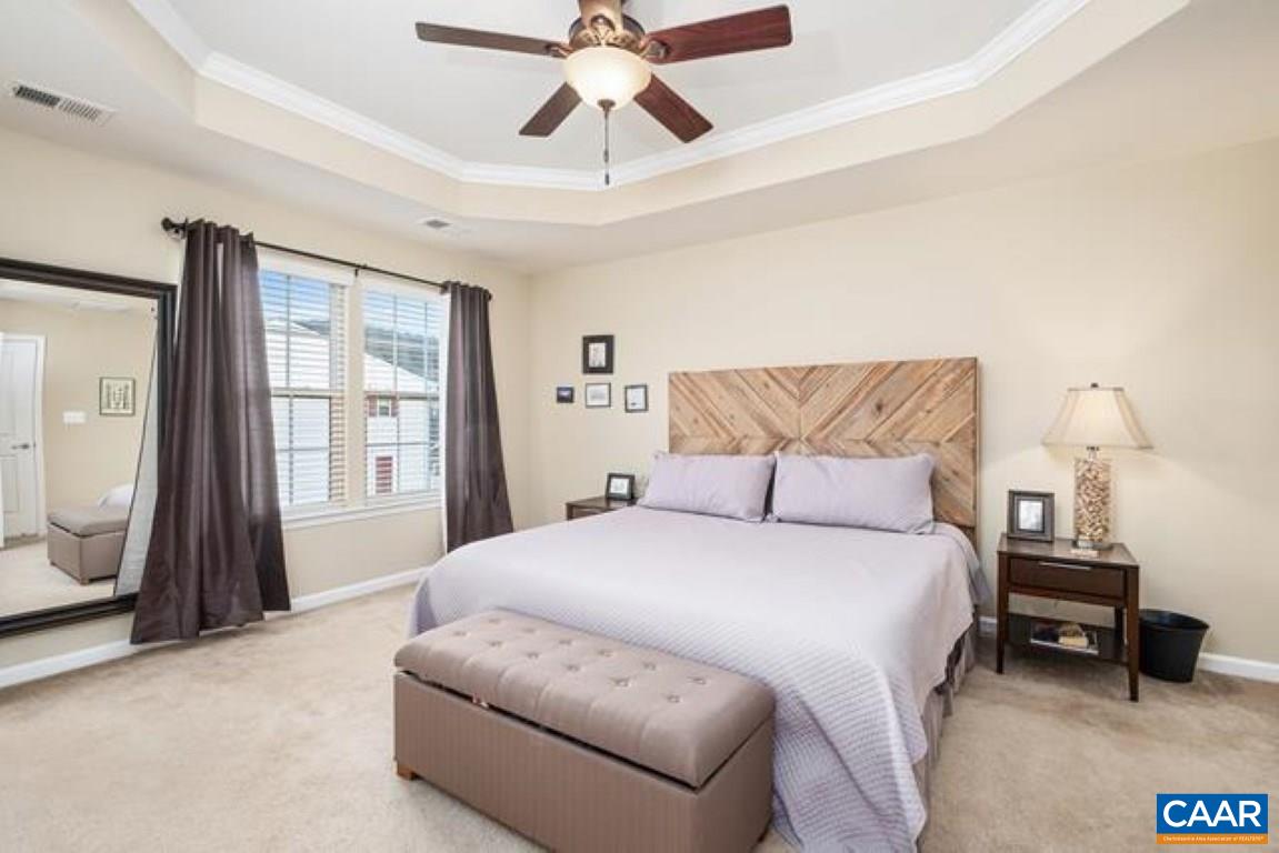 462 Rolkin Road Charlottesville, VA 22911 - Photo 14 of 30 a spacious bedroom with a bed a couch and a chandelier
