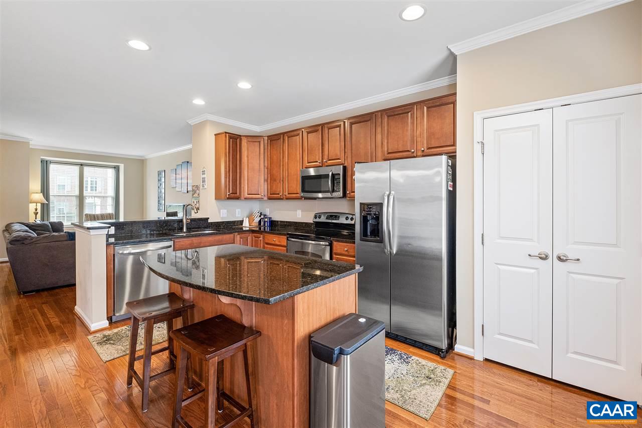 462 Rolkin Road Charlottesville, VA 22911 - Photo 3 of 30 a kitchen with stainless steel appliances granite countertop a refrigerator a sink a stove and white cabinets with wooden floor