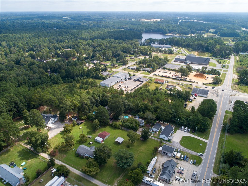 an aerial view of residential houses with outdoor space and trees