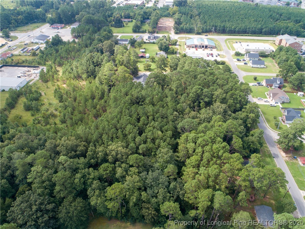 7604 Raeford Road Fayetteville, NC 28314 - Photo 13 of 20 an aerial view of residential houses with outdoor space and trees