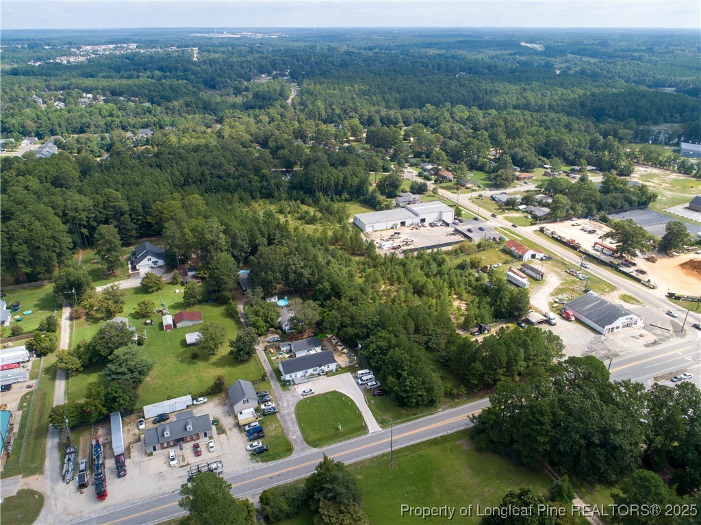 7604 Raeford Road Fayetteville, NC 28314 - Photo 9 of 20 an aerial view of residential houses with outdoor space and trees
