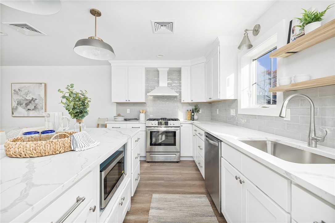 17 Nobert Street, Unit 2 Warren, RI 02885 - Photo 3 of 38 Photo is of the end unit 17 Nobert Unit 1. Same finishes. White tile backsplash instead of grey. Different styled hardware.
