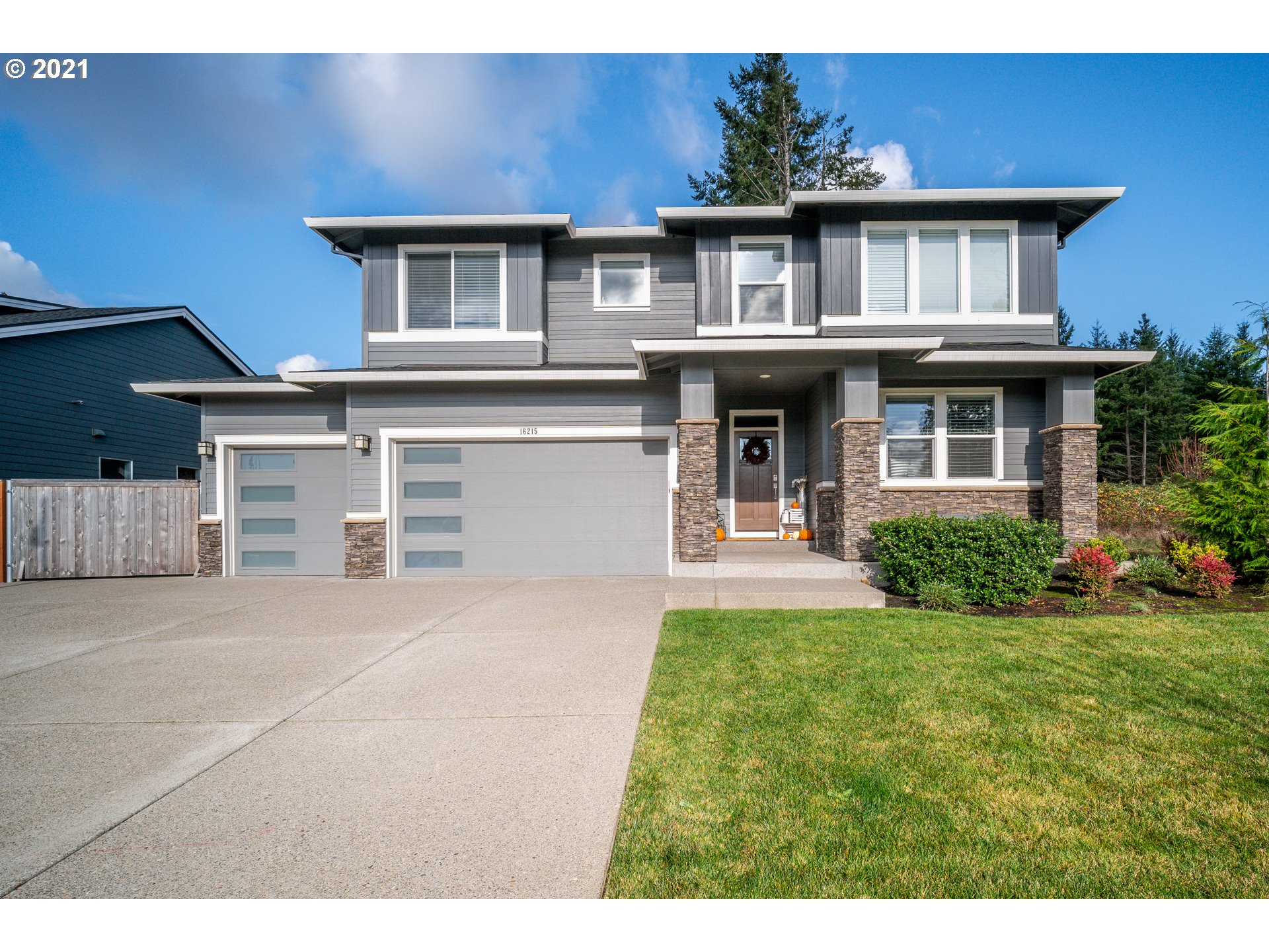16215 Jada Way Oregon City, OR 97045 - Photo 1 of 32 a front view of a house with a yard and potted plants