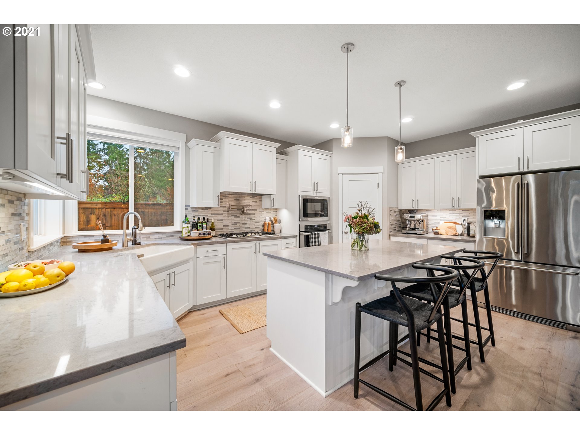 16215 Jada Way Oregon City, OR 97045 - Photo 13 of 32 a kitchen with stainless steel appliances granite countertop a table chairs sink refrigerator and cabinets