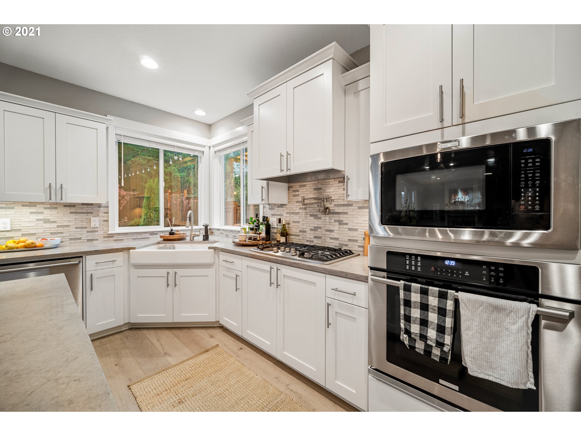 16215 Jada Way Oregon City, OR 97045 - Photo 14 of 32 a kitchen with stainless steel appliances granite countertop a stove a sink and a microwave