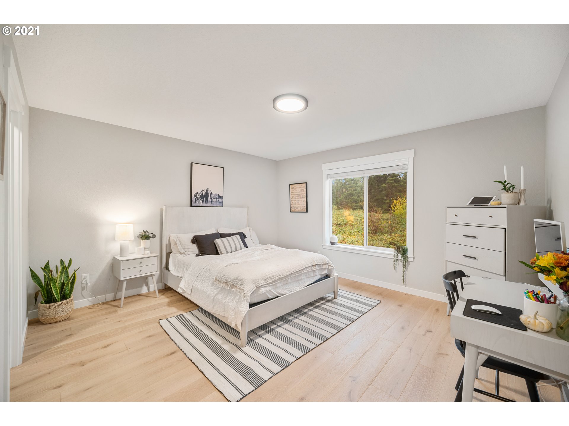 16215 Jada Way Oregon City, OR 97045 - Photo 18 of 32 a spacious bedroom with a bed a dresser and potted plant