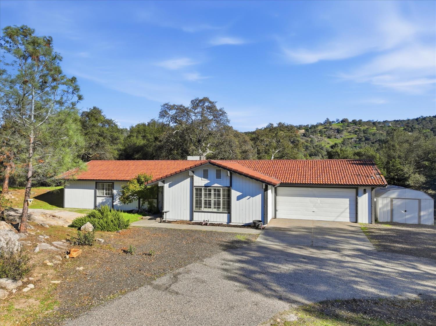 31083 Moccassin Court Coarsegold, CA 93614 - Photo 2 of 42 a house with trees in the background