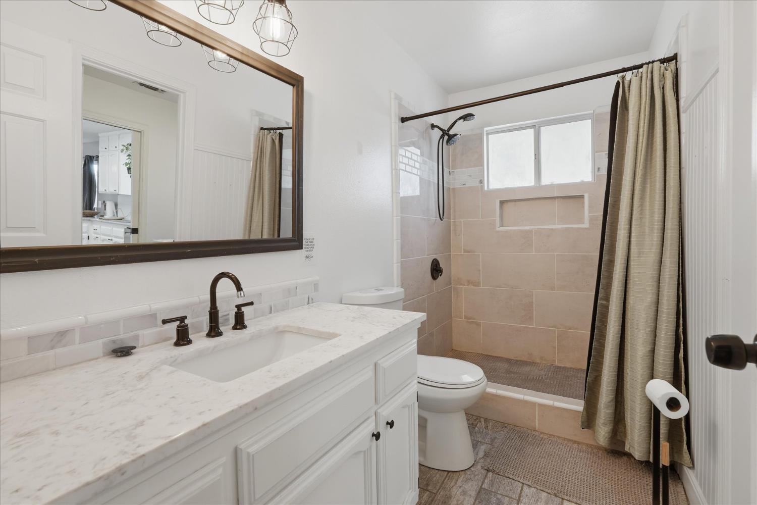 31083 Moccassin Court Coarsegold, CA 93614 - Photo 21 of 42 a bathroom with a sink a toilet and shower