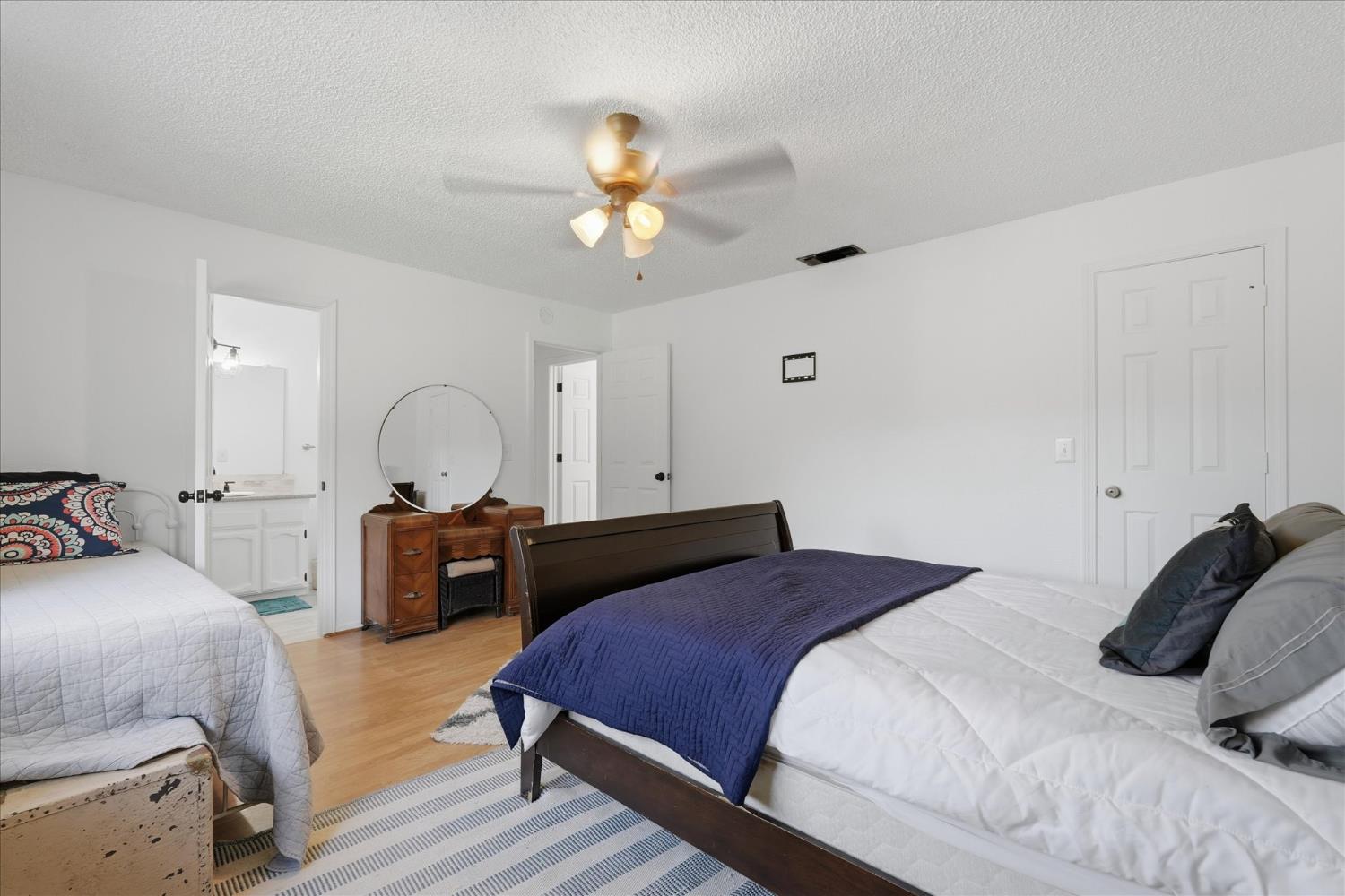 31083 Moccassin Court Coarsegold, CA 93614 - Photo 23 of 42 a bedroom with a bed and a chandelier