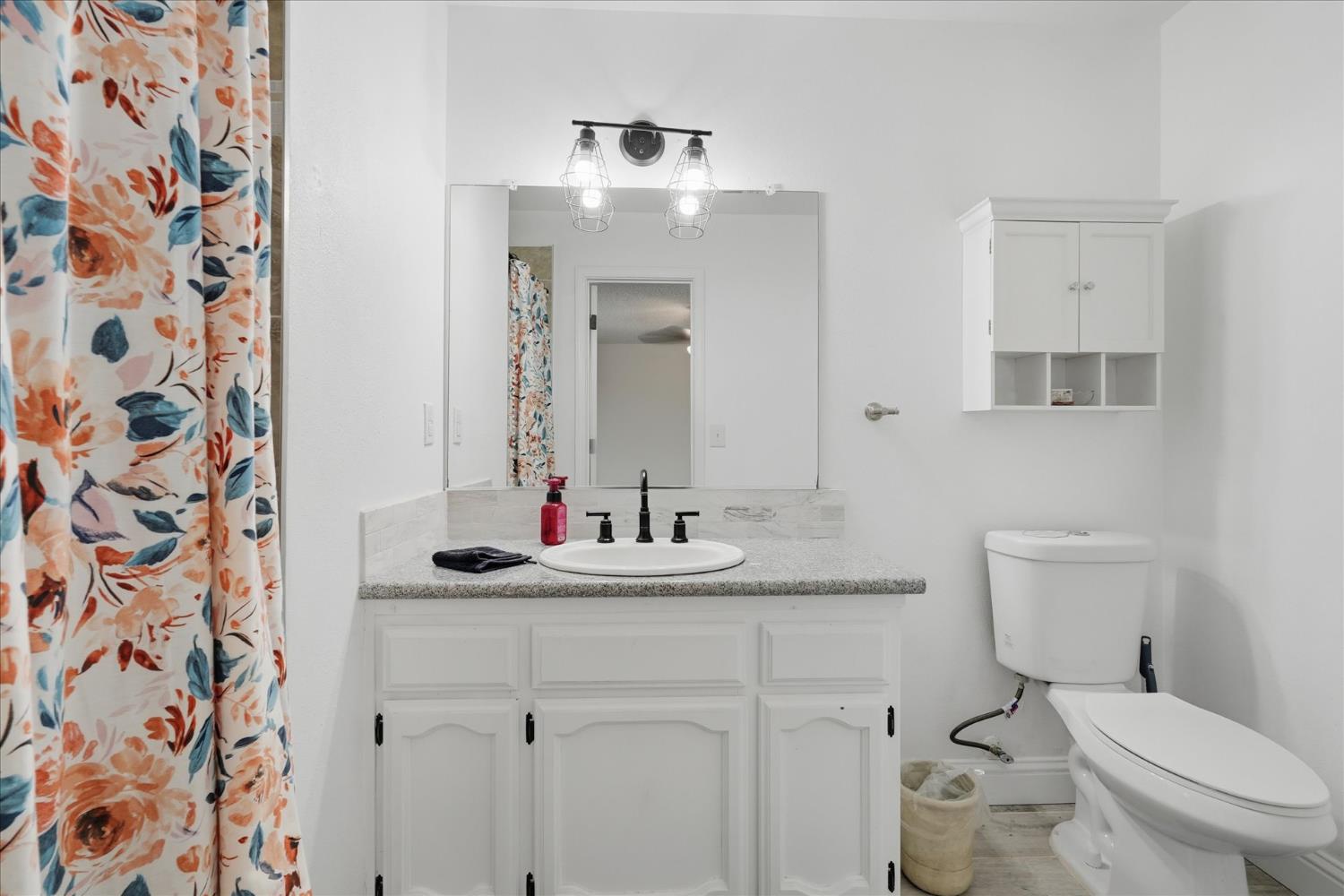 31083 Moccassin Court Coarsegold, CA 93614 - Photo 24 of 42 a bathroom with a granite countertop sink and a mirror