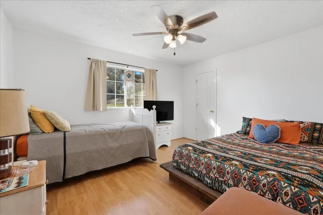 a bedroom with two beds and a window