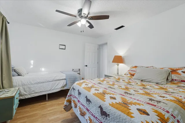 a bedroom with a bed and a chandelier