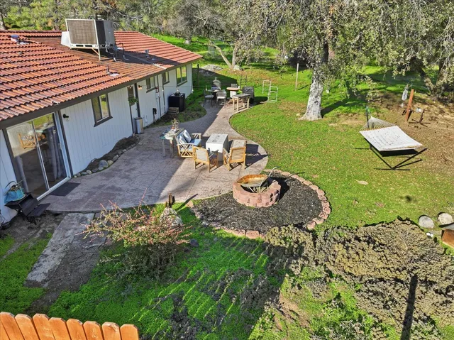 a view of a patio with table and chairs potted plants