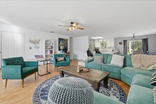 a living room with furniture a rug and a chandelier