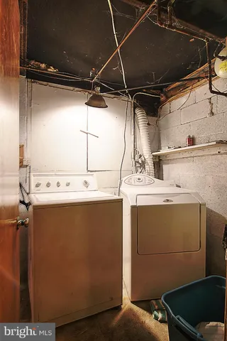 a front view of a house with a yard and potted plants