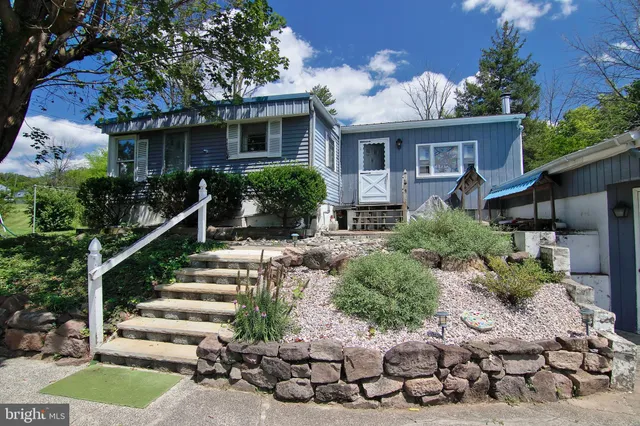 a front view of house with yard outdoor seating and green space
