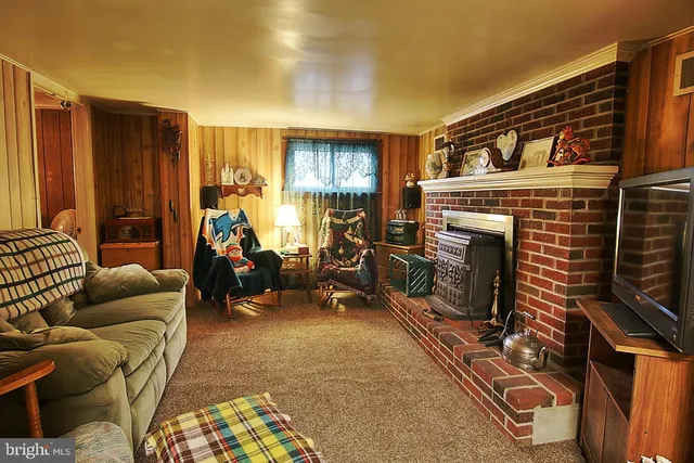 a living room with furniture a window and a fireplace