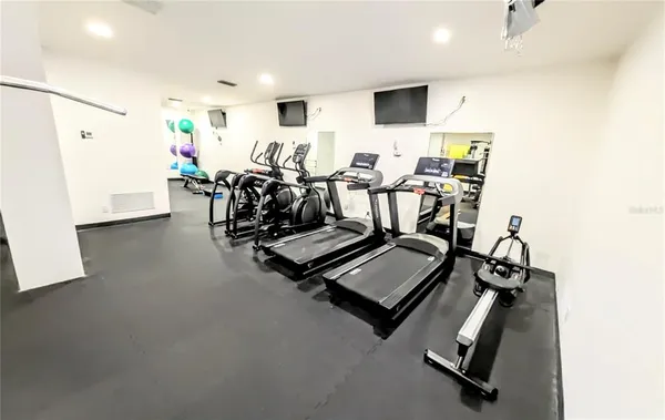 a view of a living room with furniture and wooden floor