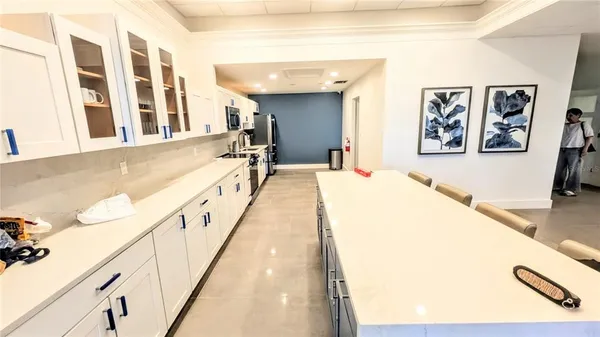 a view of a park with a slide and potted plants