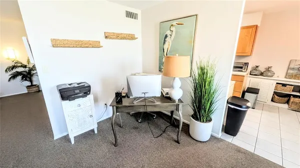 a view of a workspace with furniture and a potted plant