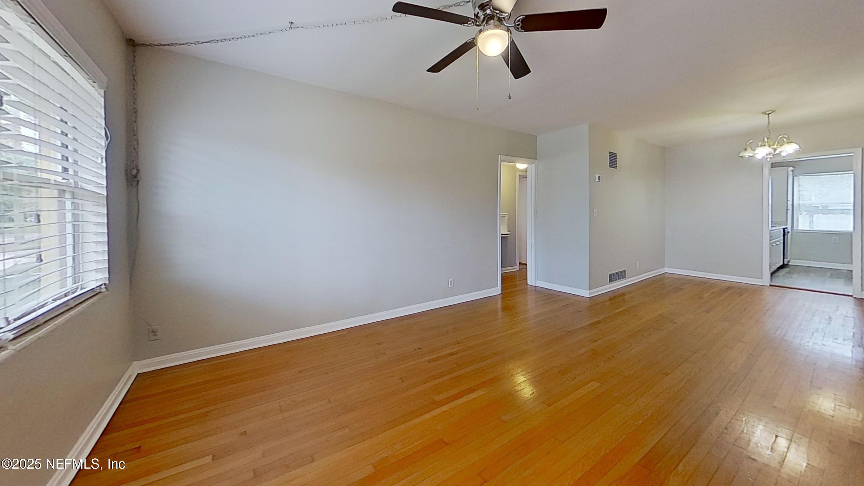 1543 Nicholson Road, Unit 1 Jacksonville, FL 32207 - Photo 8 of 16 a view of empty room with wooden floor and fan