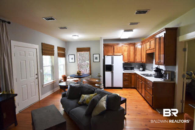 13848 Elmwood Court Stapleton, AL 36578 - Photo 15 of 27 This home features a guest suite with kitchenette, dining and living area, bedroom, bath plus a separate entrance with small side porch and view of wildflower garden and pond.