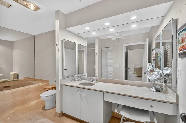 a bathroom with a double vanity sink toilet and a mirror