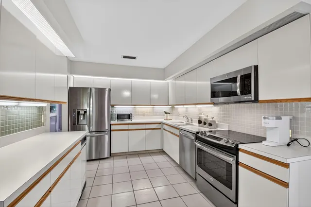 a kitchen with a sink and stainless steel appliances