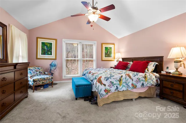 a bedroom with a bed and ceiling fan