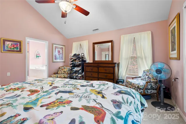 a bedroom that has a bed dresser and a chair in it