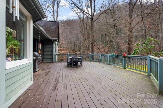 a view of house with deck outdoor seating and wooden floor