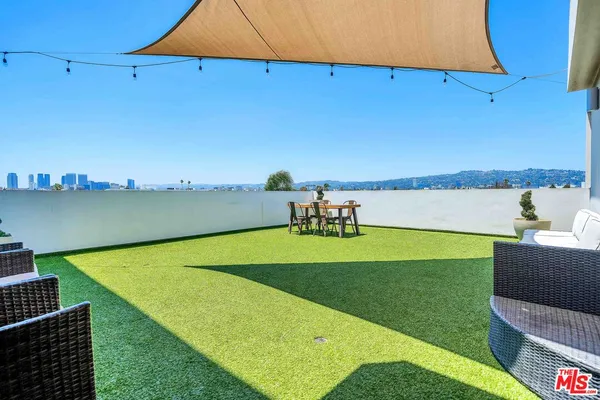 a view of a swimming pool with an outdoor seating and yard