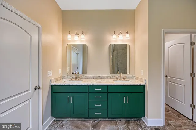 a bathroom with a granite countertop sink a toilet and shower