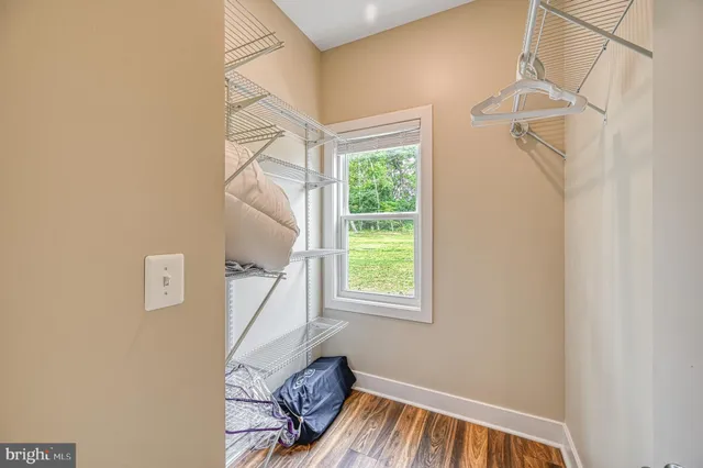 a bathroom with a granite countertop double vanity sink mirror and shower
