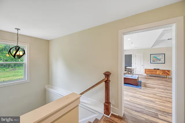 an aerial view of lake residential house with outdoor space and trees around