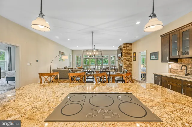 a living room with couches and a large window with outer view