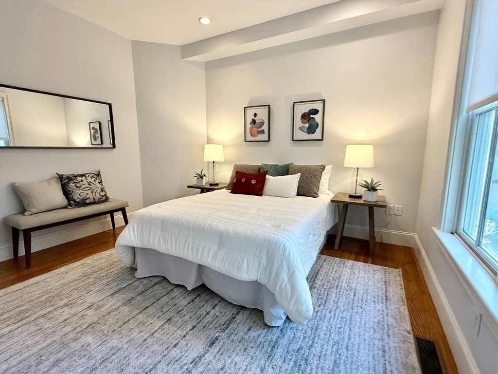 16 A Meehan Street, Unit 1 Boston, MA 02130 - Photo 13 of 16 a spacious bedroom with a bed and a couch