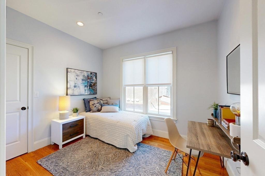 16 A Meehan Street, Unit 1 Boston, MA 02130 - Photo 14 of 16 a bedroom with furniture and a window