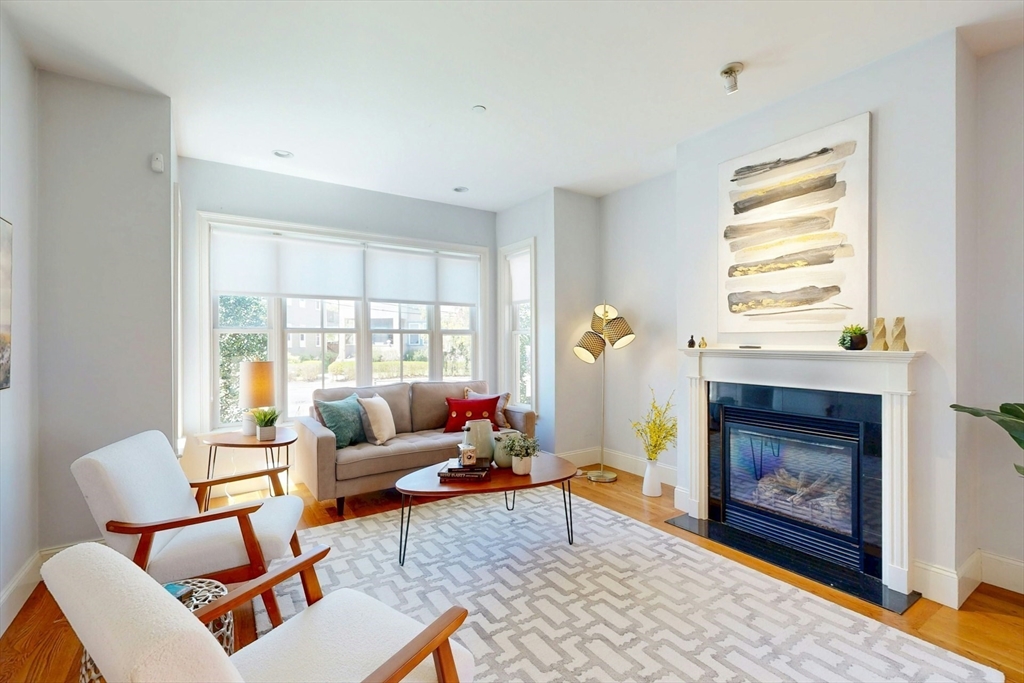 16 A Meehan Street, Unit 1 Boston, MA 02130 - Photo 2 of 16 a living room with furniture a window and a fireplace
