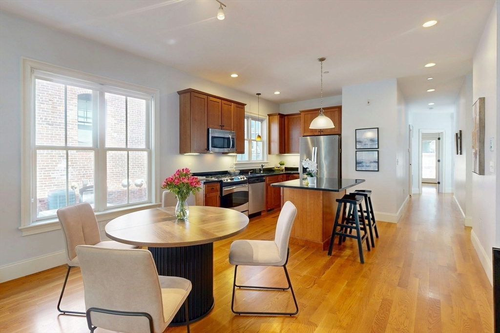 16 A Meehan Street, Unit 1 Boston, MA 02130 - Photo 4 of 16 a dining room with furniture a window and a kitchen view