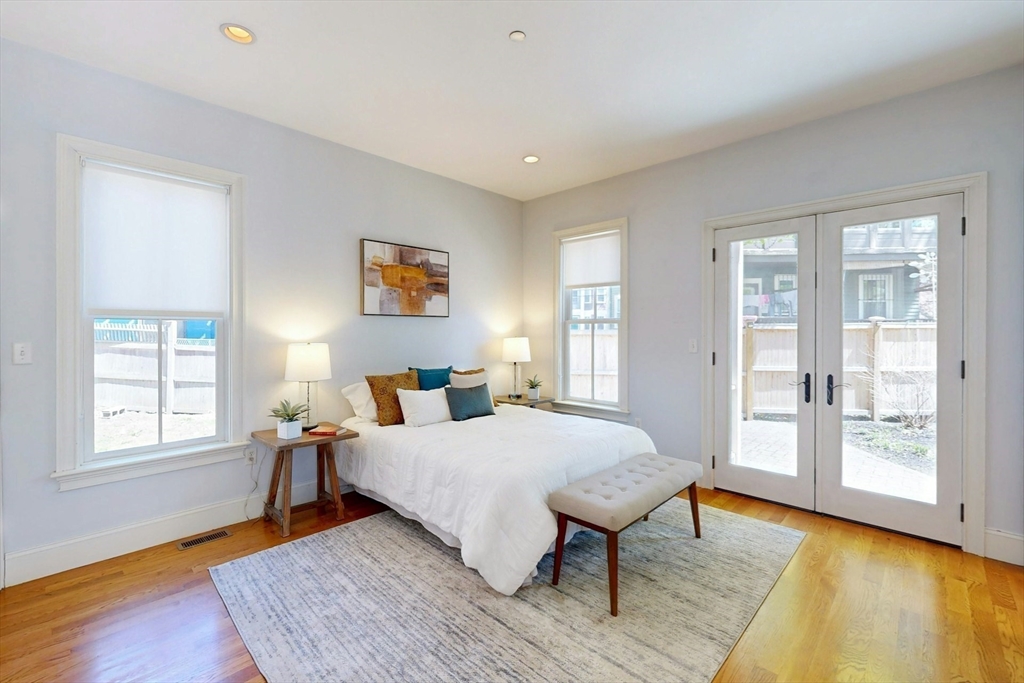 16 A Meehan Street, Unit 1 Boston, MA 02130 - Photo 8 of 16 a bedroom with a bed and wooden floor