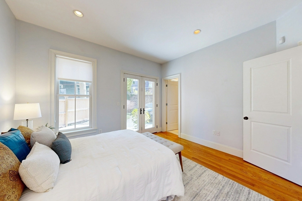 16 A Meehan Street, Unit 1 Boston, MA 02130 - Photo 10 of 16 a bedroom with a bed and wooden floor