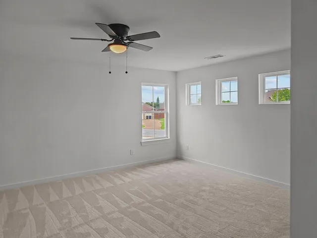 a view of room with a ceiling fan and window