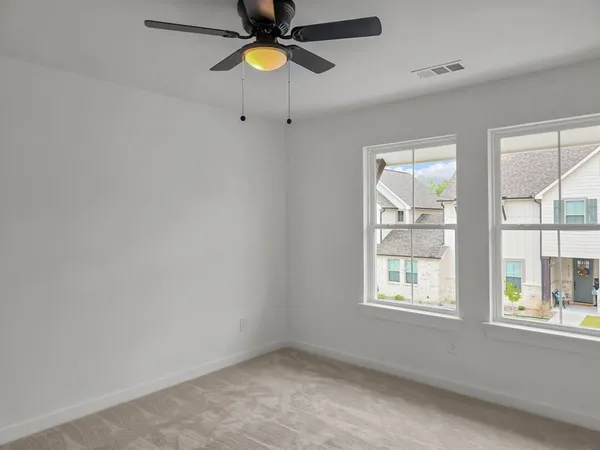 an empty room with windows and entrance