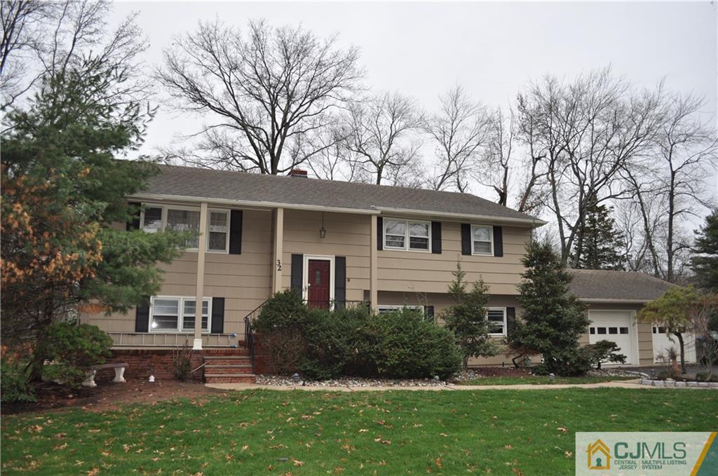 32 Nottingham Road Edison, NJ 08820 - Photo 1 of 25 a front view of a house with a yard and trees